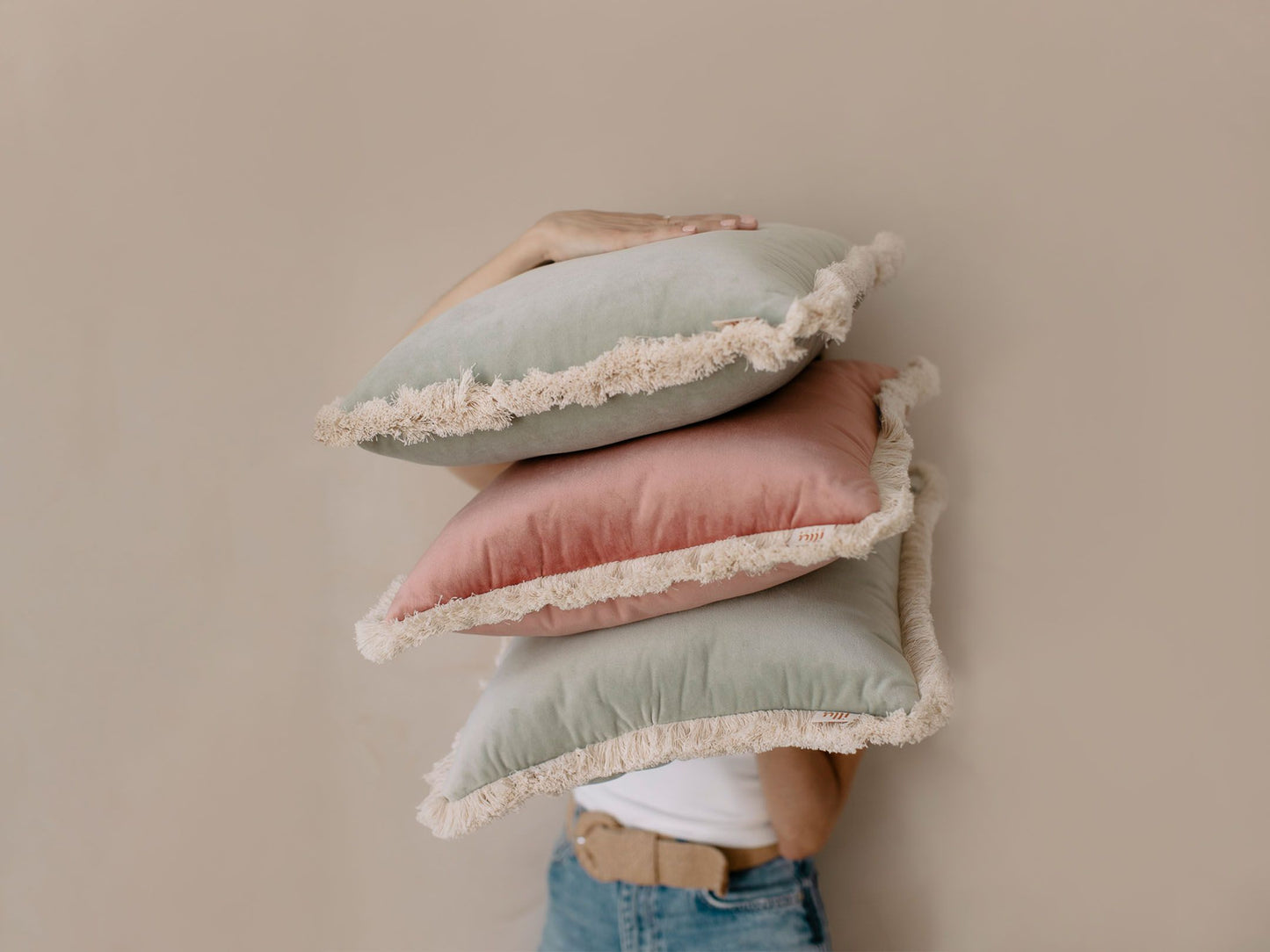 girl holding pastel pink pillow