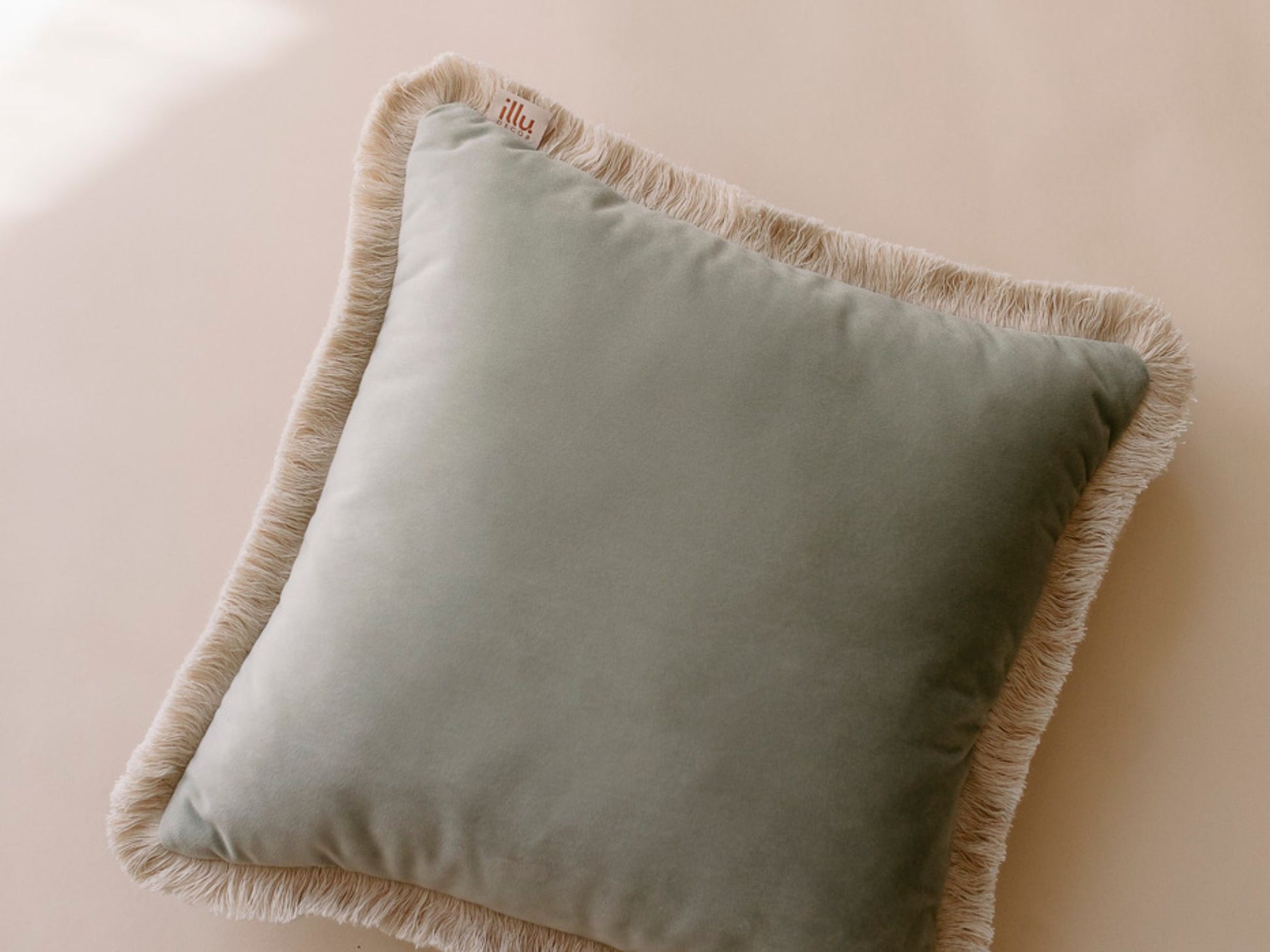 cotton fringe of a velvet cushion