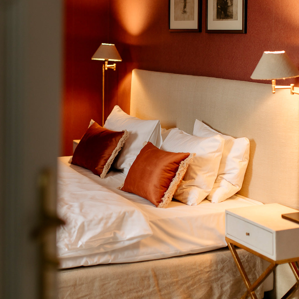 Hotel room with premium orange decorative cushions