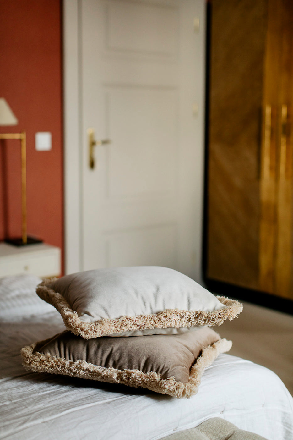 white and brown pillows on the bed