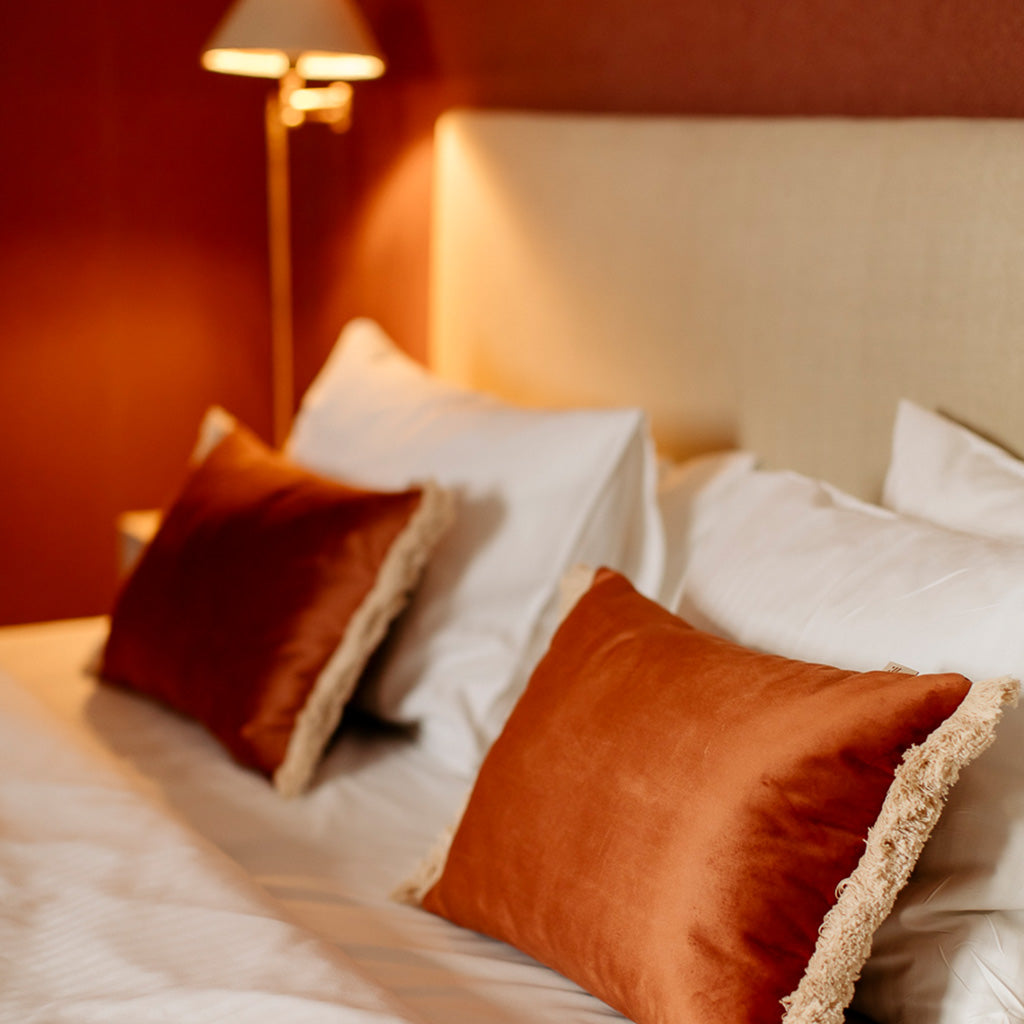 Terracota rust premium cushion on hotel bed