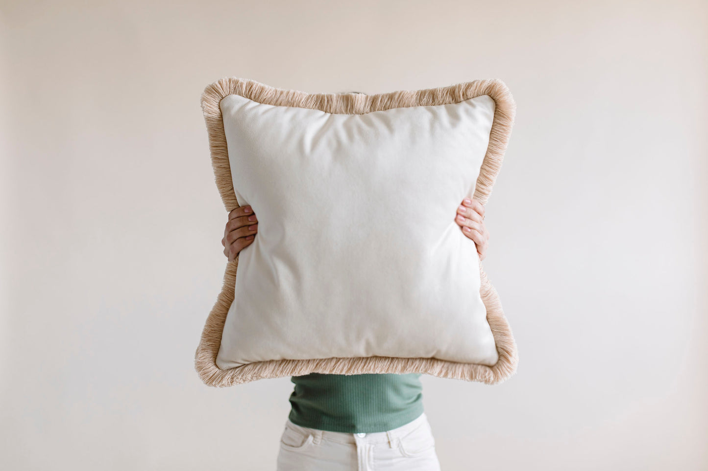 a girl holding big white velvet cushion