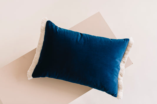 navy velvet cushion with a cotton fringe